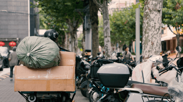 Motorcyclist carrying a full load on the street
