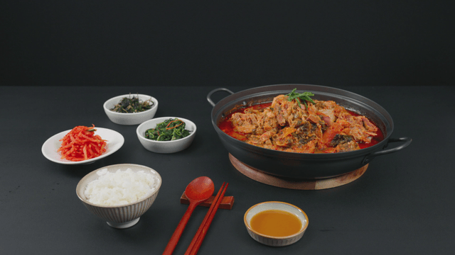 Table set with pork backbone stew and side dishes