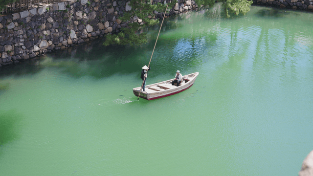 Two people on a boat in a serene river