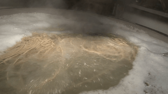 Noodles being cooked in boiling water