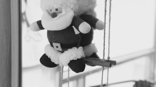 Santa Claus doll hanging by mirror