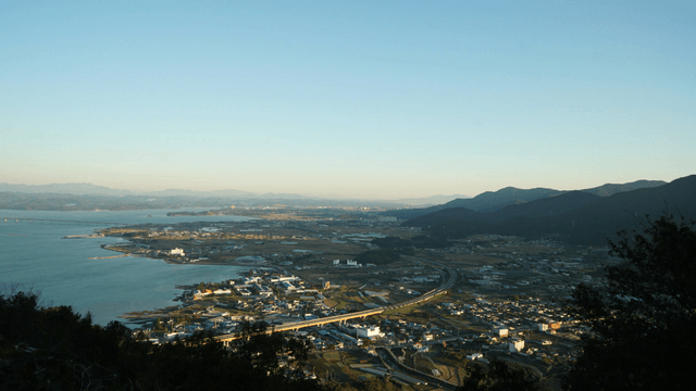 Coastal town with mountains in the distance