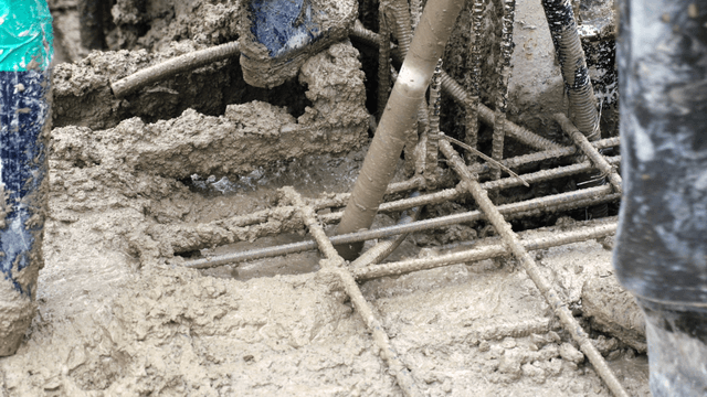 Concrete being poured over rebar at a construction site