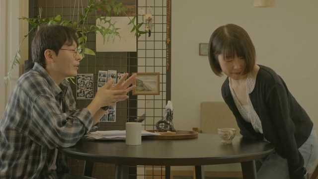 Tense moment at cafe table between couple