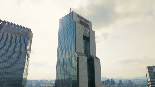Tall skyscraper against a cloudy sky