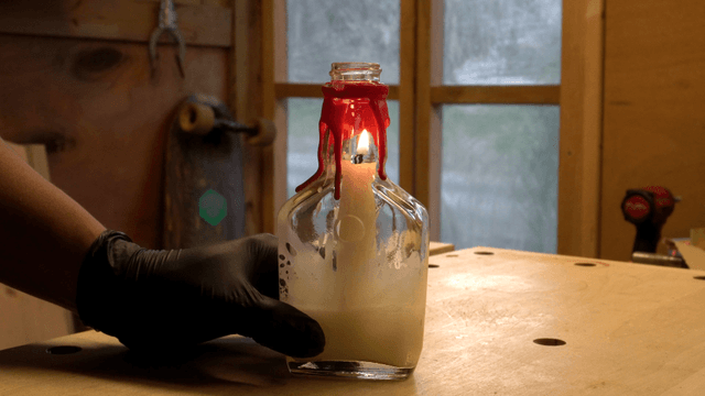Candle burning inside a glass bottle