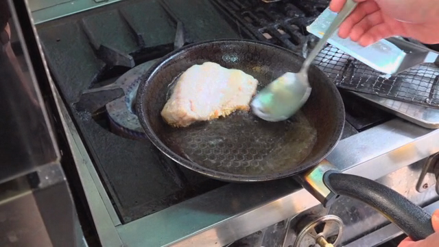 Fish being fried in a pan