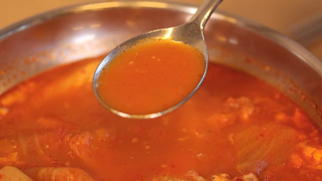 A spoonful of Kimchi jjigae broth