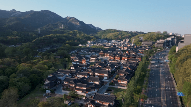 Traditional Korean hanok village beneath mountain