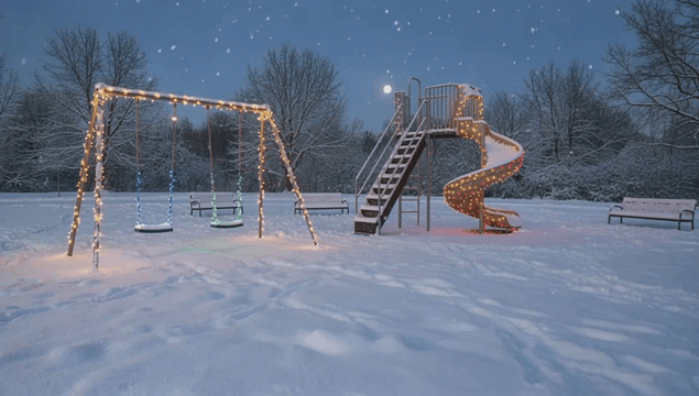 크리스마스 조명이 있는 눈 덮인 놀이터