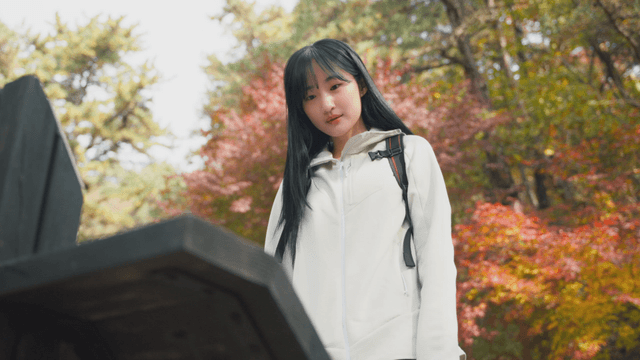 Woman checking mountain sign in autumn forest