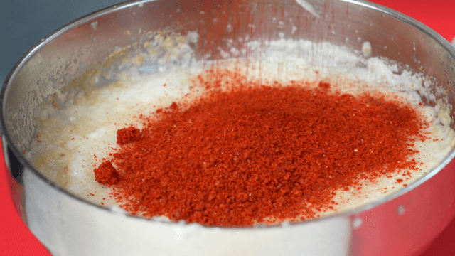 Red fine chili powder added to livered onion and garlic