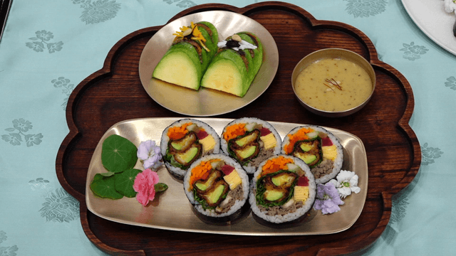 Neatly arranged pumpkin gimbap with side dishes