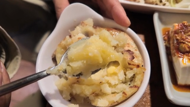 A spoonful of mashed potatoes with butter