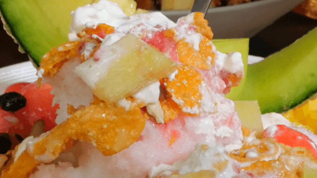 A spoonful of fruit shaved ice with cereal