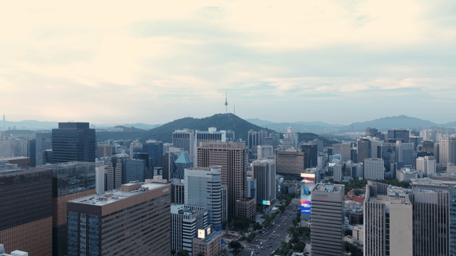 Bustling cityscape with a mountain backdrop