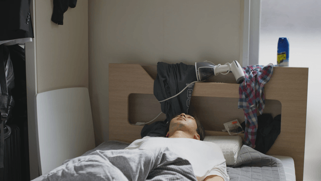 Man sleeping in a tidy bedroom