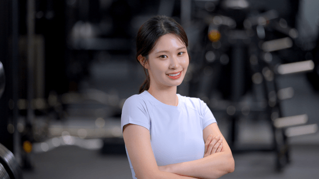 Young woman smiling confidently at the gym