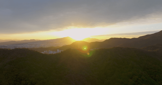 Sunset over mountains and cityscape