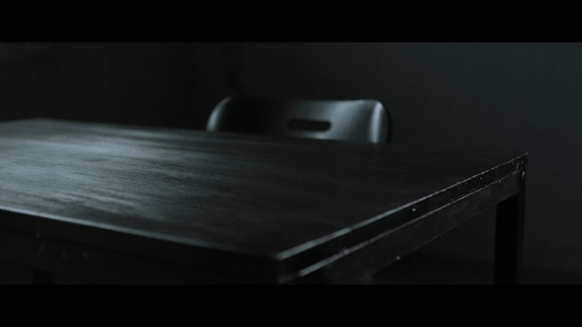 Dark room with a table and chair