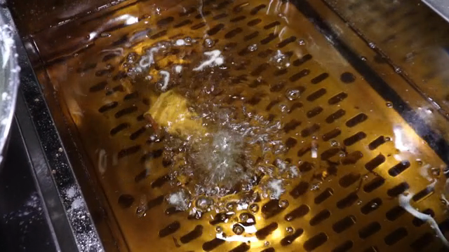 Batter-coated food being deep-fried