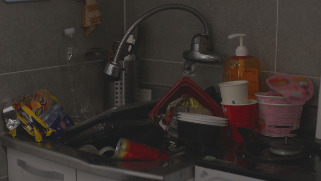 Kitchen sink filled with dishes and garbage