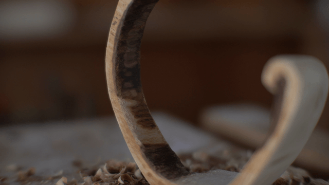 Semi-circular wooden piece on workbench