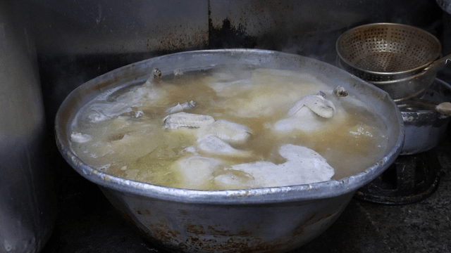 Chicken boiling in a large pot