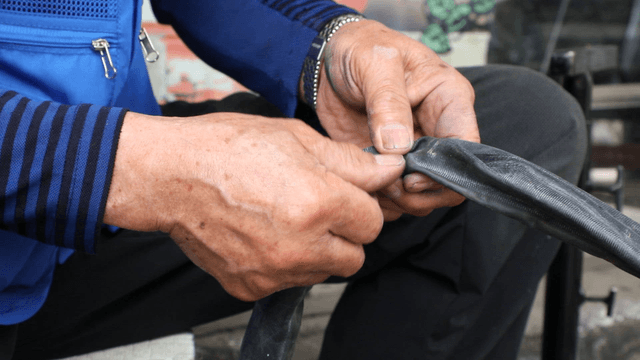 Hands repairing a bicycle tire tube