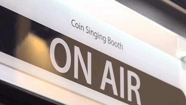 Coin singing booth with on-air sign