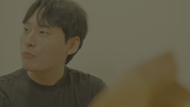 Young man speaking while looking aside in black t shirt