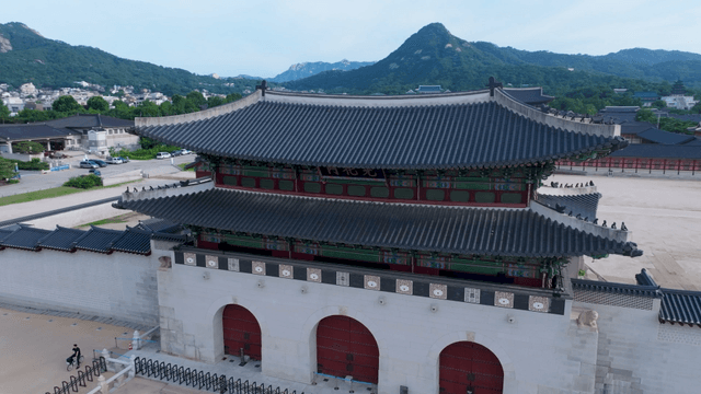Traditional Korean palace with mountain backdrop