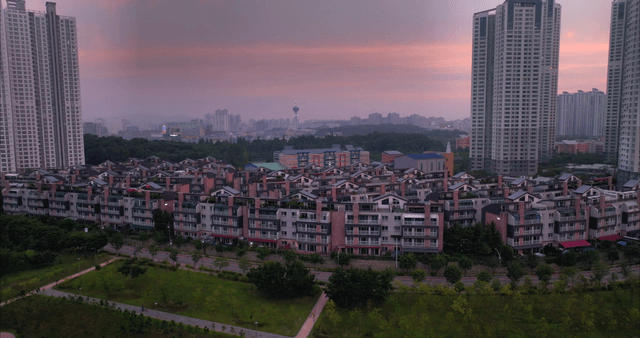 Villas between high-rise buildings at sunset