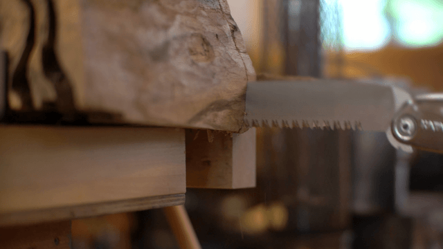 Saw rapidly cutting through a piece of wood