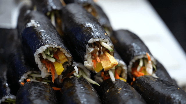 Freshly made kimbap rolls stacked together