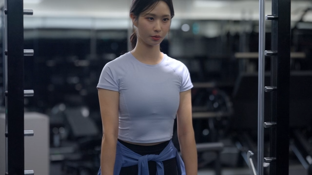 Young woman doing deadlift in gym