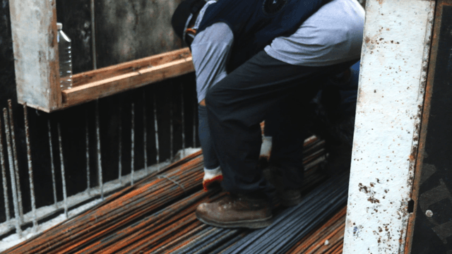 Construction site with steel rods and workers