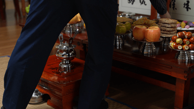 Traditional holiday ritual offering liquor on memorial table