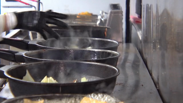 Multiple pans steaming on a stove