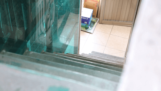 Indoor staircase with cleaning supplies