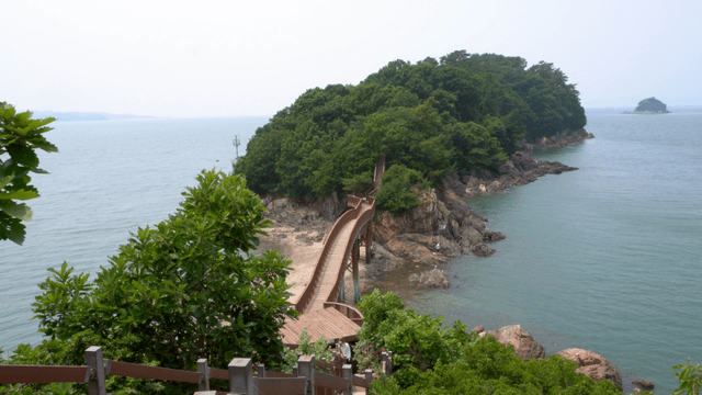 A scenic walkway leading to a lush island