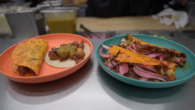Tacos being served on colorful plates