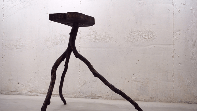 Unique wooden stool in a minimalist room