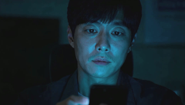 Man using smartphone in a dimly lit room