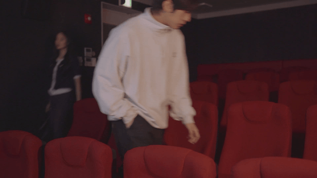 Couple enters the theater and sits separately