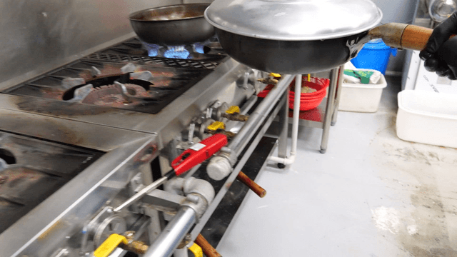 Chef moving pan with lid to the shelf