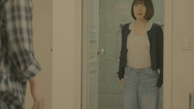 Man watching woman coming out of bathroom at home