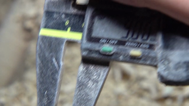 Caliper measuring a wooden object
