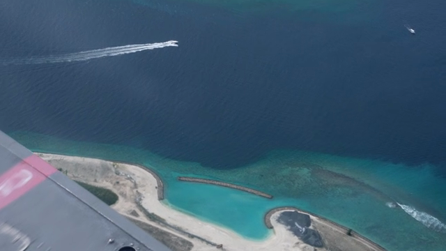 Aerial view of a coastal island with clear waters