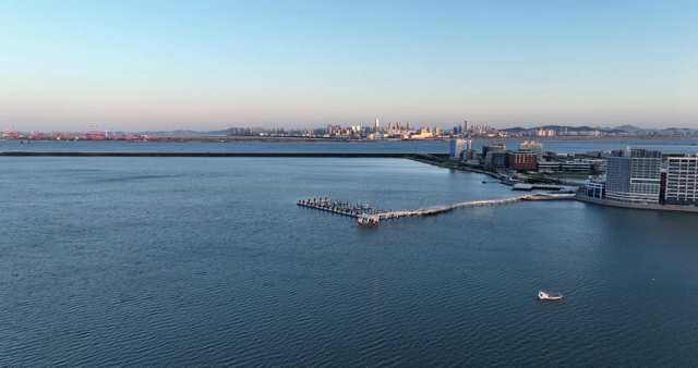 A city skyline with a calm sea
